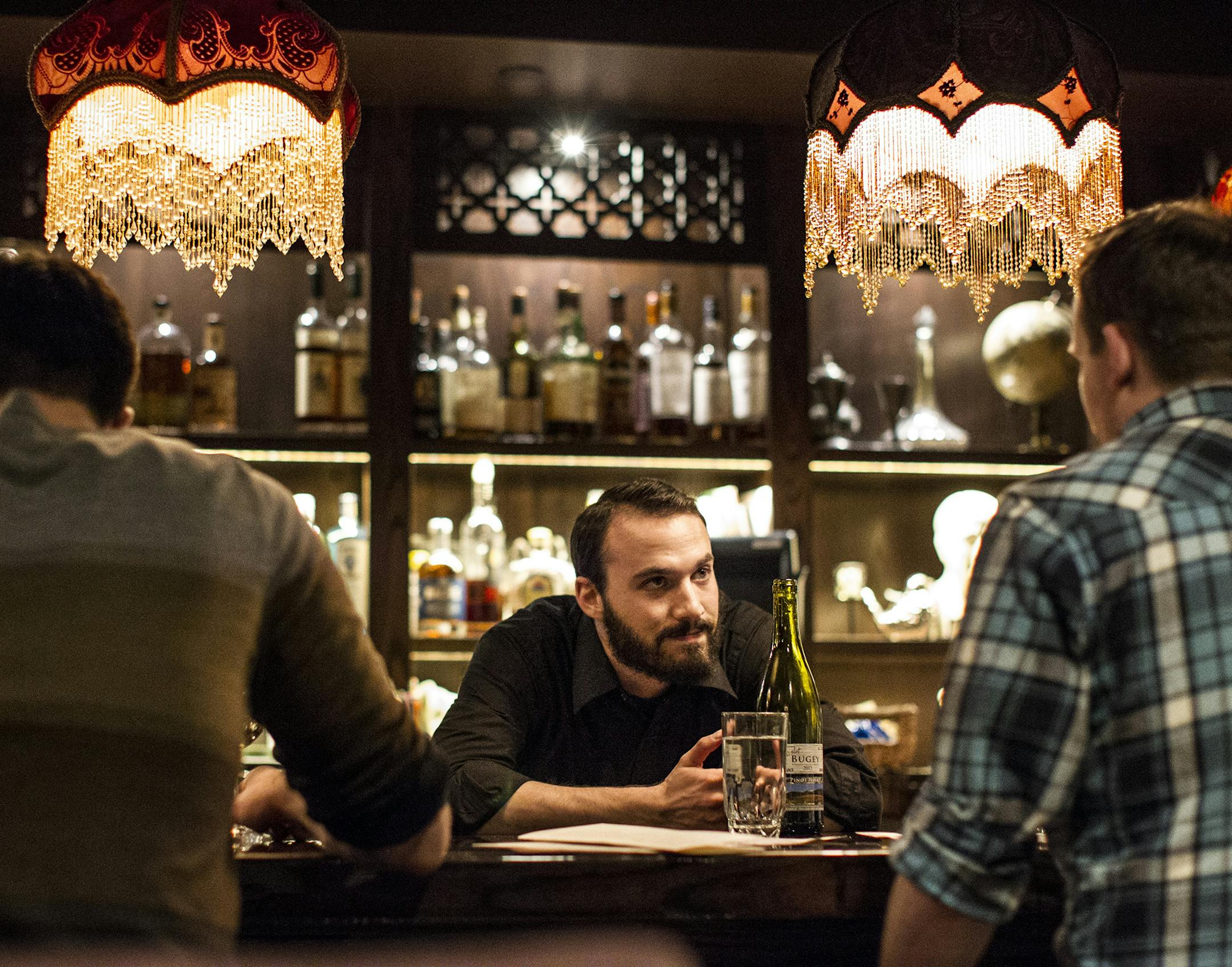 Bartender Aaron Zaidman talks with customers at Foreign Legion in Minneapolis March 23, 2015. (Courtney Perry)
