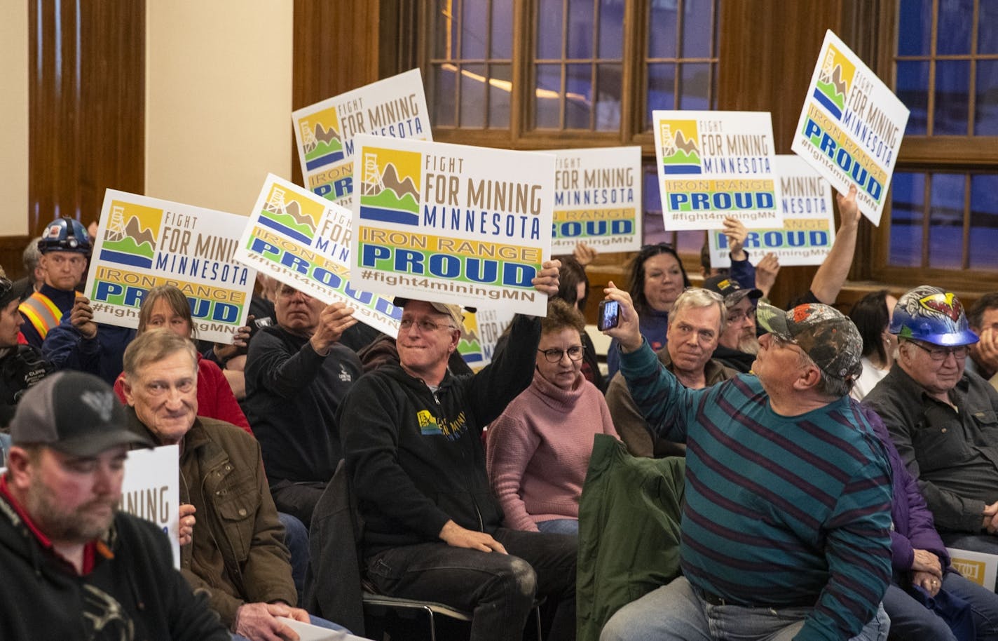 Supporters of mining and a boycott of Fortune Bay Casino held up signs at the Ely City Council meeting.