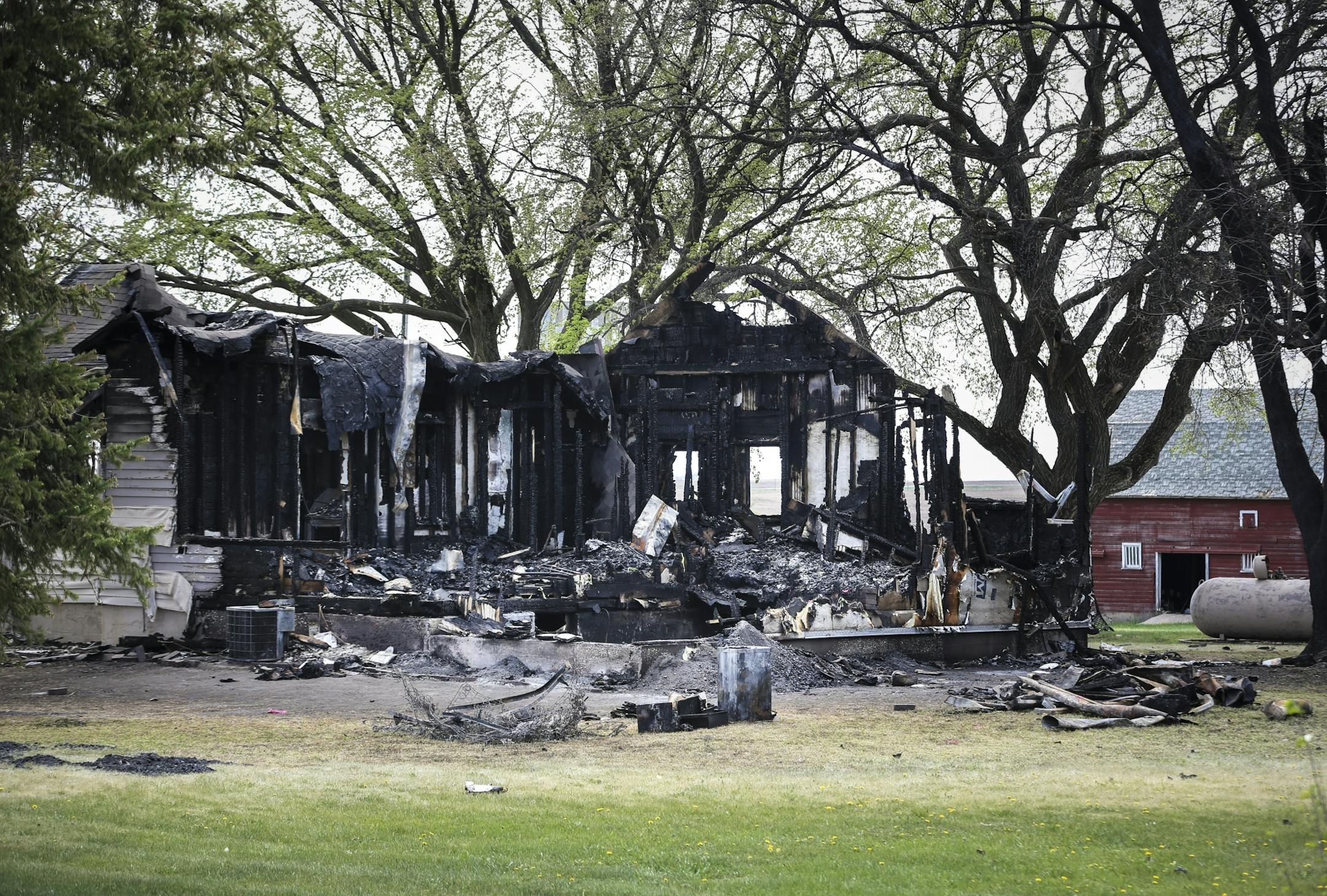The burned farmhouse at the scene of a double homicide on Monday, May 4, 2015,in Balaton, Minn.