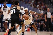 Jamal Murray (27) of the Nuggets looks to drive past Nickeil Alexander-Walker (9) of the Timberwolves during the first quarter of Game 2 on Monday.