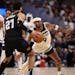 Jamal Murray (27) of the Nuggets looks to drive past Nickeil Alexander-Walker (9) of the Timberwolves during the first quarter of Game 2 on Monday.