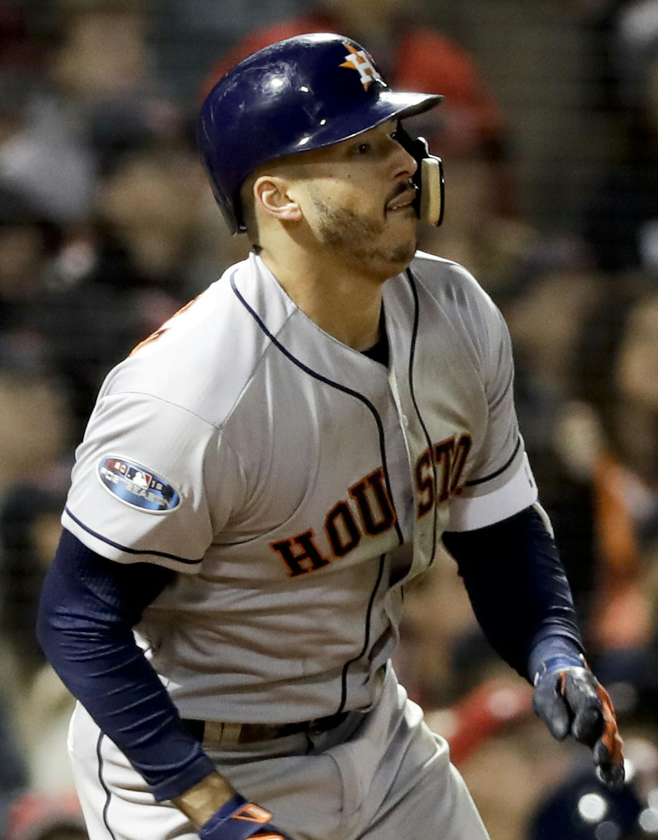 Houston Astros' Carlos Correa watch his RBI-single against the Boston Red Sox during the sixth inning in Game 1 of a baseball American League Championship Series on Saturday, Oct. 13, 2018, in Boston. (AP Photo/David J. Phillip)