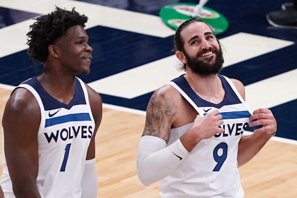 Minnesota Timberwolves guard Anthony Edwards (1) and Minnesota Timberwolves guard Ricky Rubio (9) joked with each other as they took the court after a