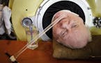 Paul Alexander looks out from inside his iron lung at his home in Dallas on Friday, April 27, 2018. Now in his 70s, Alexander is one of the few people