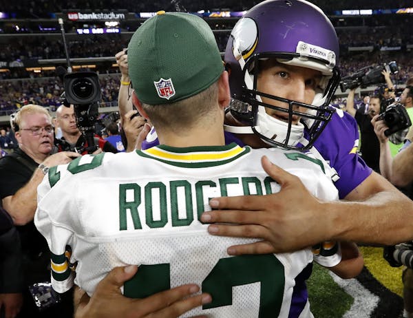 Green Bay Packers quarterback Aaron Rodgers (12) and Minnesota Vikings quarterback Sam Bradford greeted each other at the end of the game.