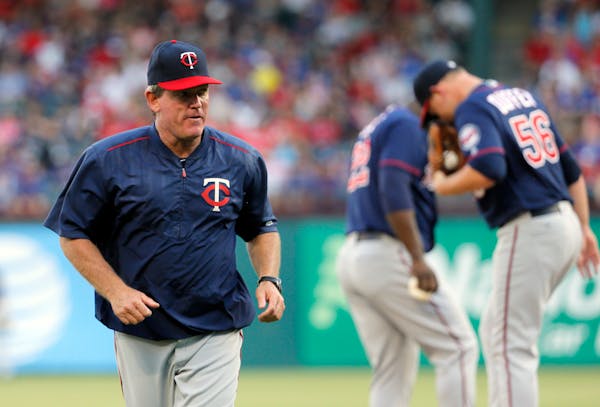 Minnesota Twins pitching coach Neil Allen jogs back to the dugout after paying starting pitcher Tyler Duffey a visit on the mound in the first inning 