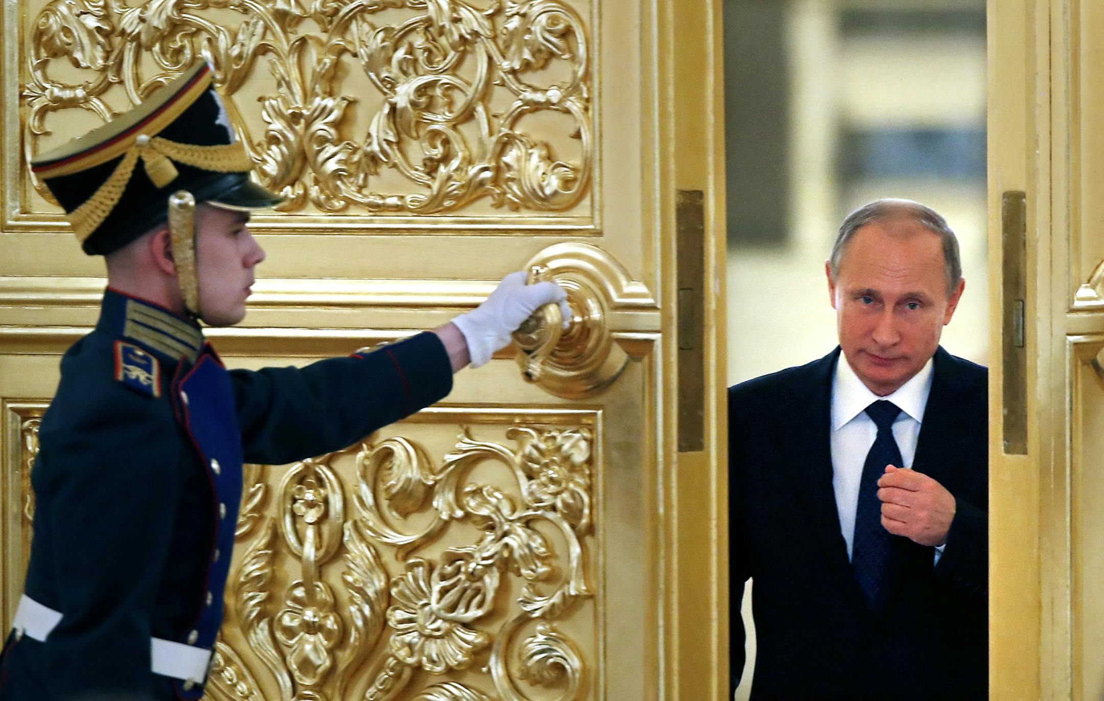 Russian President Vladimir Putin, right, enters the Alexadrovsky Hall to head a meeting of the Presidential Council for Civil Society and Human Rights at the Kremlin in Moscow, Russia, Thursday, Oct. 1, 2015. (Yuri Kochetkov/Pool photo via AP)