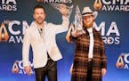 T.J. Osborne, left, and John Osborne of Brothers Osborne celebrate CMA Award for best vocal duo 