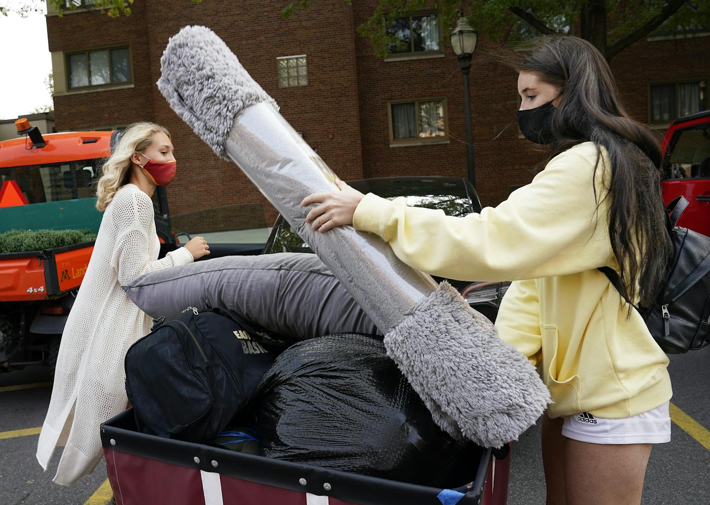 University of Minnesota freshman Chloe Wienholz, left, of Stillwater, and Savanna Hatzenbuhler, of Woodbury, loaded belongings into carts to transport to their new dorm rooms on campus Tuesday, in Minneapolis. ] DAVID JOLES • david.joles@startribune.com