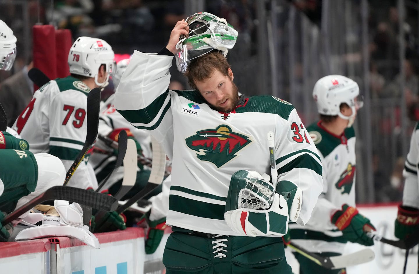 Minnesota Wild goaltender Filip Gustavsson puts on his mask after a quick repair in the first period of an NHL preseason hockey game against the Colorado Avalanche Tuesday, Sept. 27, 2022, in Denver. (AP Photo/David Zalubowski)