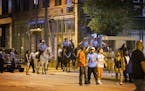 Minneapolis Police officers on horses clear the streets in the early morning after the clubs have closed in downtown Minneapolis on Sunday, June 21, 2
