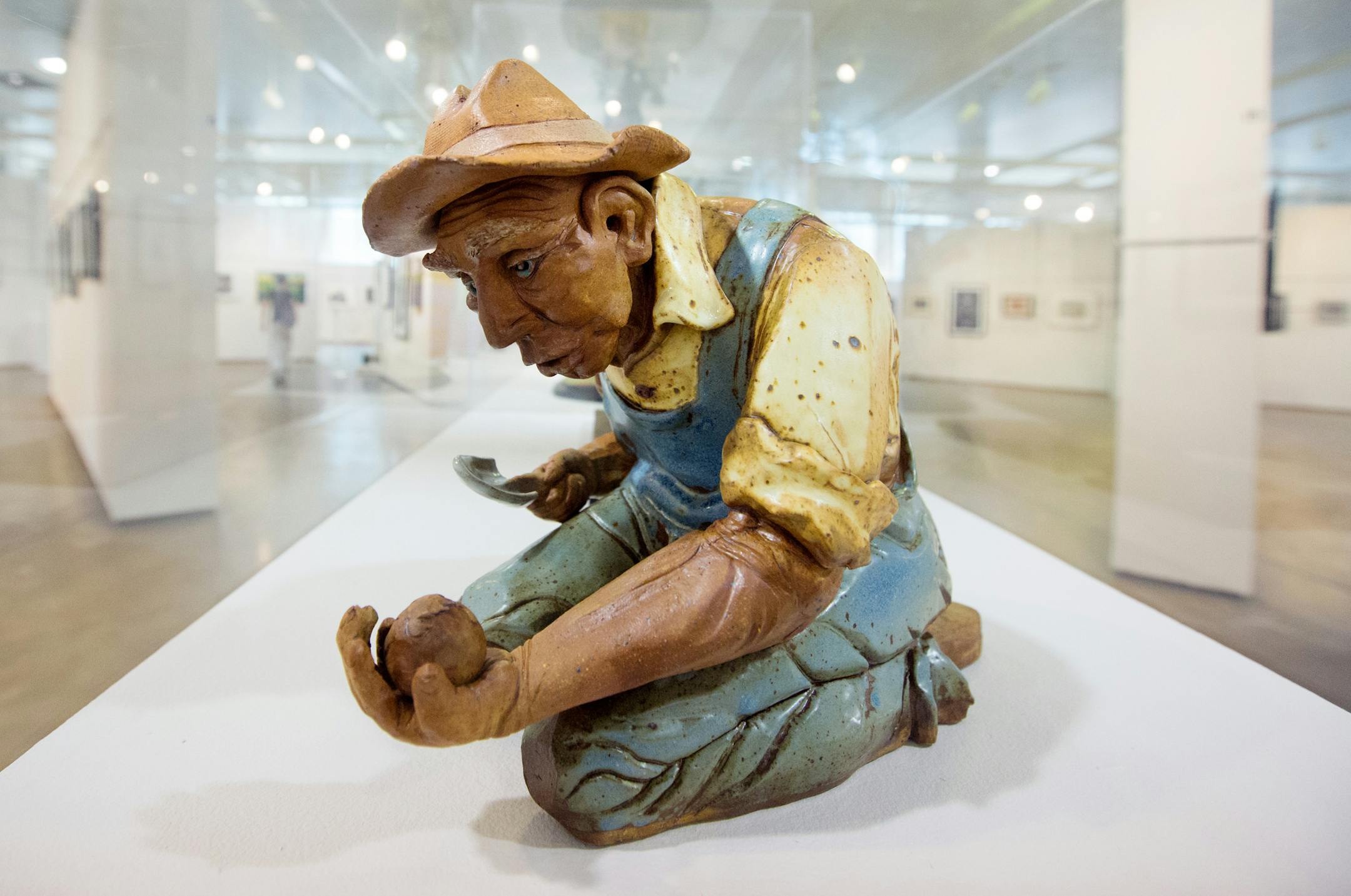 1) "Caretaker of the Earth," a basketball-sized ceramic figure by M. E. Pitz of a crouching farmer/gardener. ] Review of Minnesota State Fair art show BRIAN PETERSON ‚Ä¢ brian.peterson@startribune.com Falcon Heights, MN 08/19/14