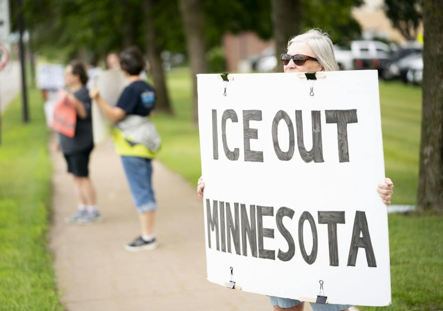 Nancy Hassett participated in a weekly Wednesday afternoon protest outside the Sherburne County courthouse to oppose the county jail's holding of hundreds of ICE detainees in Elk River, Minn. Wednesday, July 10, 2019. She has been doing this protest for over a year.