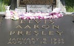 Flowers and tributes left by fans decorate Elvis Presley's grave at Graceland, his Memphis, Tenn. home, on Monday, Aug. 16, 2010. Elvis Presley fans f