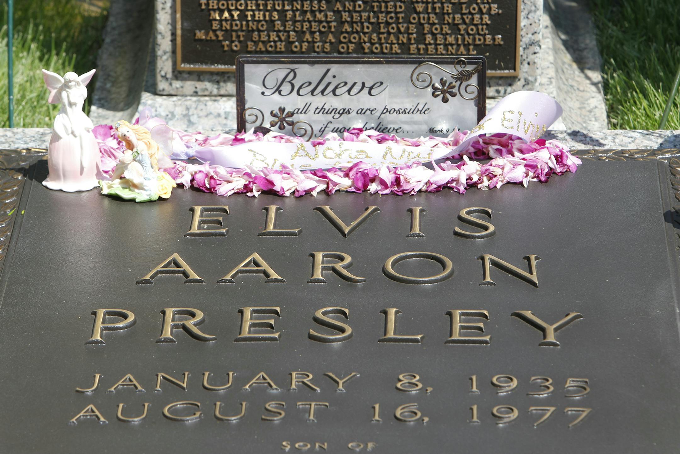 Flowers and tributes left by fans decorate Elvis Presley's grave at Graceland, his Memphis, Tenn. home, on Monday, Aug. 16, 2010. Elvis Presley fans from around the world have come to Graceland for the annual remembrance of his death. Presley died at his Graceland mansion Aug. 16, 1977. (AP Photo/Mark Humphrey) ORG XMIT: OTK