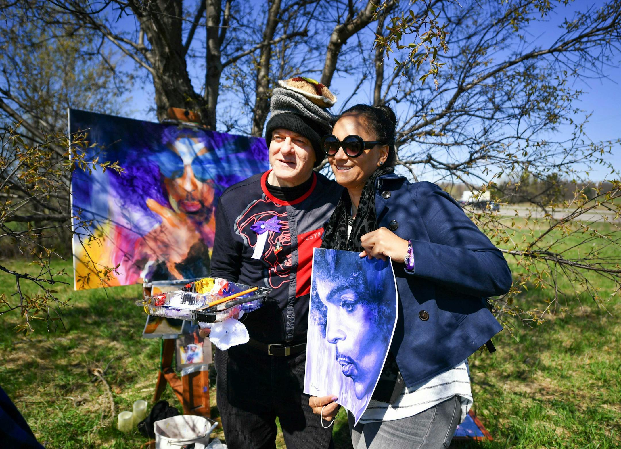Dan Lacey posed with a print that he gave to Timesha Carroll who travelled from Washington, D.C. to visit Paisley Park. Dan also known as "Painter of Pancakes" didn't charge for his prints outside Paisley Park. ] GLEN STUBBE • glen.stubbe@startribune.com Friday, April 21 2017 Fans came to Prince's Paisley Park on the first anniversary of his death.