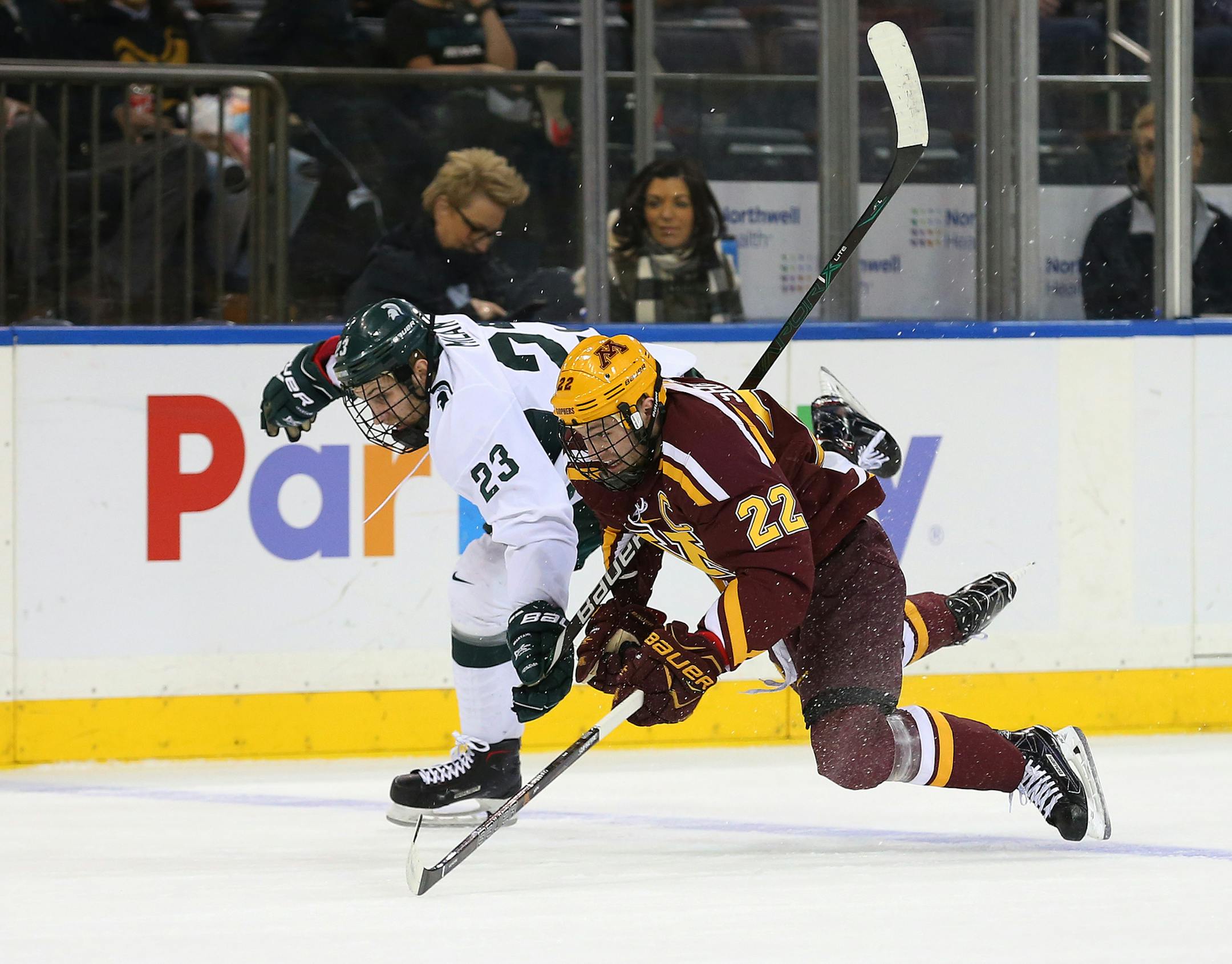 SPECIAL TO MINNEAPOLIS STAR TRIBUNE -- Michigan State Spartans forward Cody Milan (23) collides with Minnesota Golden Gophers forward Tyler Sheehy (22) during the first period of a hockey game at Madison Square Garden. Saturday, Jan. 20, 2018, in New York. (AP Photo/Rich Schultz) ORG XMIT: NYRS202