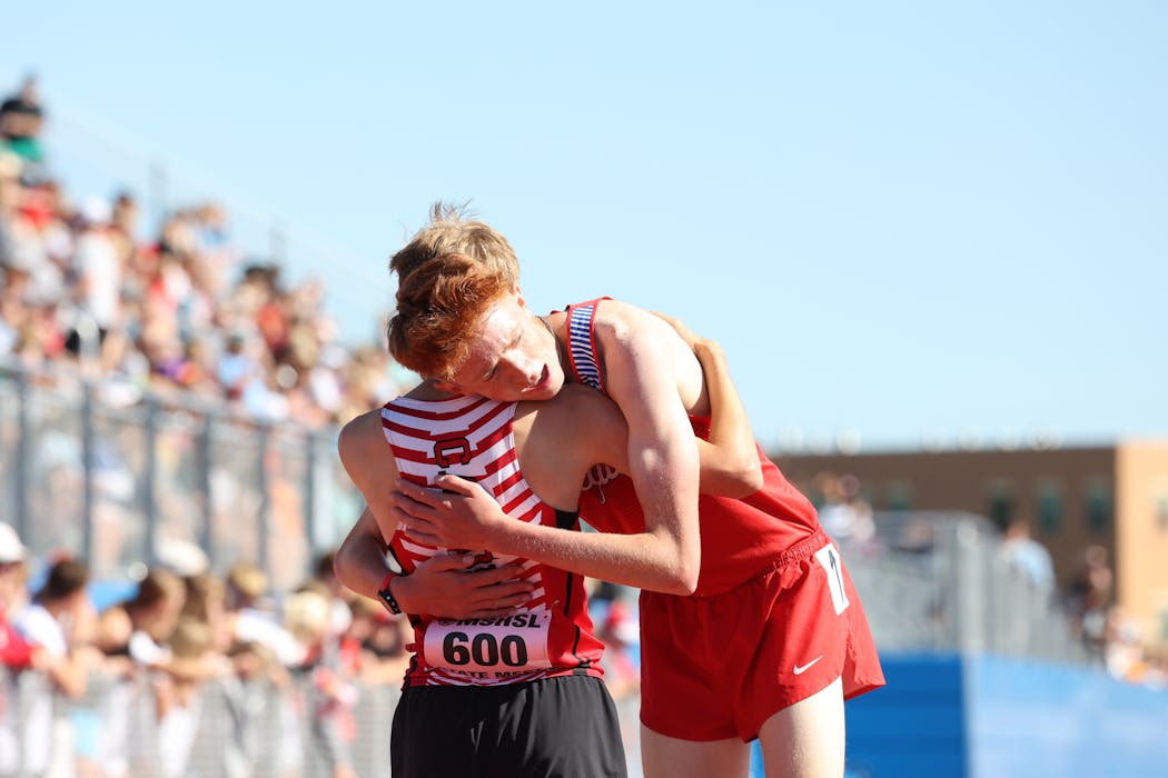 Salvador Wirth of Annandale and Eli Hall of Pequot Lakes hugged after competing down the stretch.