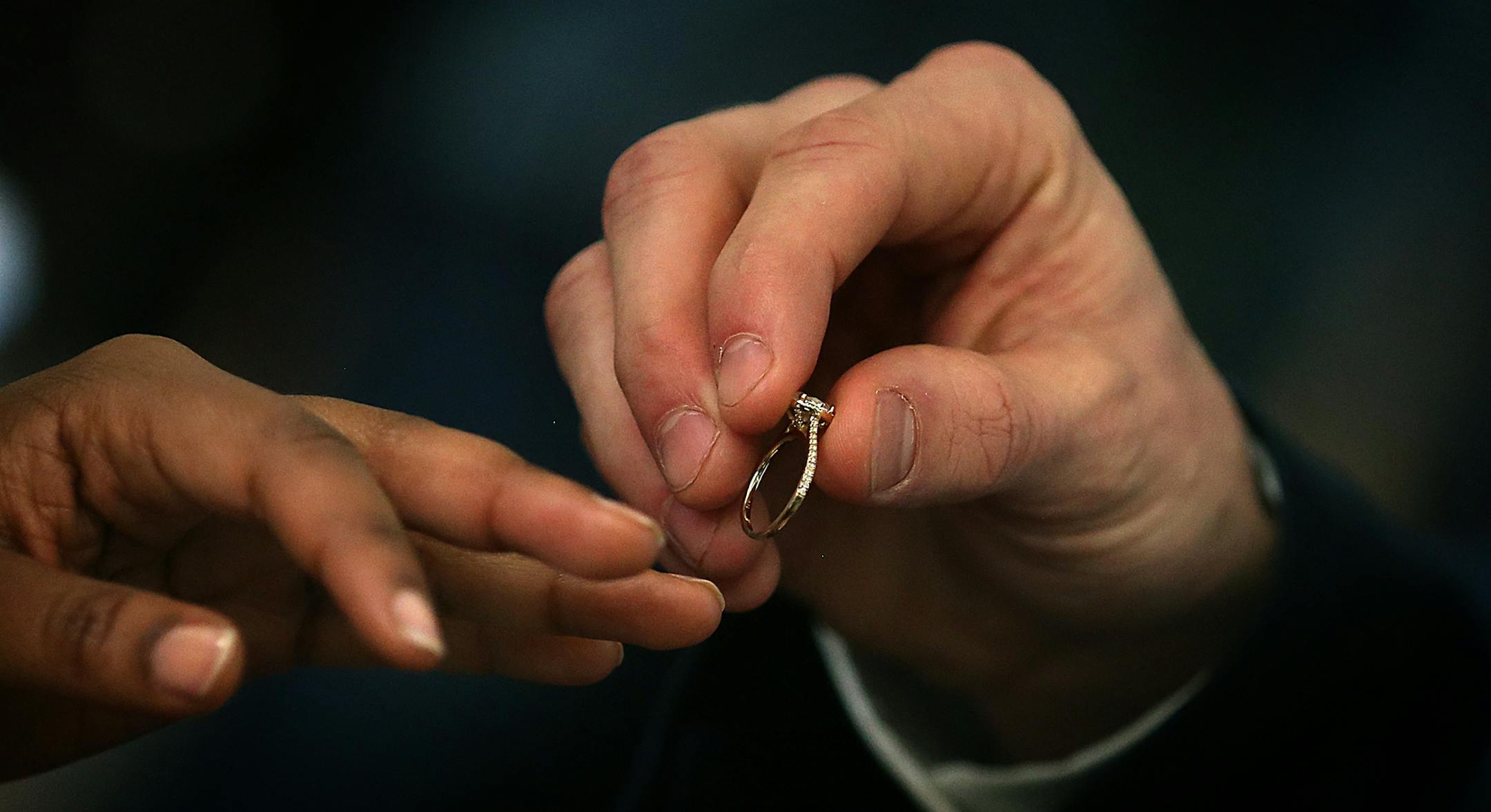 Pat Dalton placed a wedding ring on the finger of bride Julie Gicheru. ] JIM GEHRZ &#xef; james.gehrz@startribune.com / Minneapolis, MN / February 12, 2016 /12:00 PM &#xf1; BACKGROUND INFORMATION : Fourth Judicial District judges will unite 34 couples in matrimony at no charge on Friday, February 12, 2016. More than 100 couples have been united at the Valentine&#xed;s Day weekend annual event. A quartet, Musica Ipsa Loquitor, featuring the Honorable Elizabeth Cutter will play throughout the marr