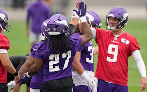 Vikings quarterback J.J. McCarthy hands out high-fives Wednesday during the team's minicamp at TCO Performance Center.