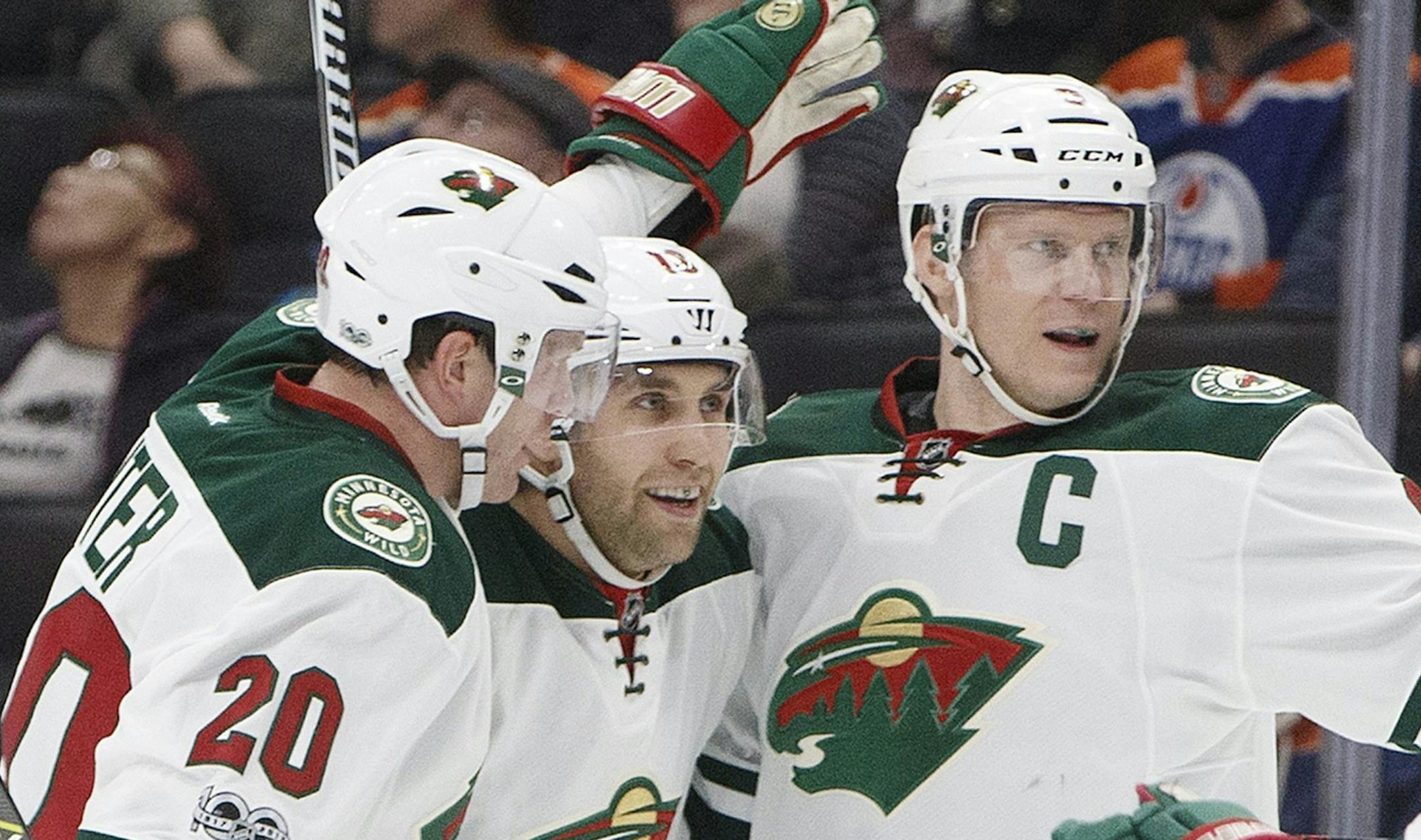 Minnesota Wild defenseman Ryan Suter (20), left wing Jason Zucker (16) and centre Mikko Koivu (9) celebrate a goal against the Edmonton Oilers during the first period of an NHL hockey game Tuesday, Jan. 31, 2017, in Edmonton, Alberta. (Jason Franson/The Canadian Press via AP)