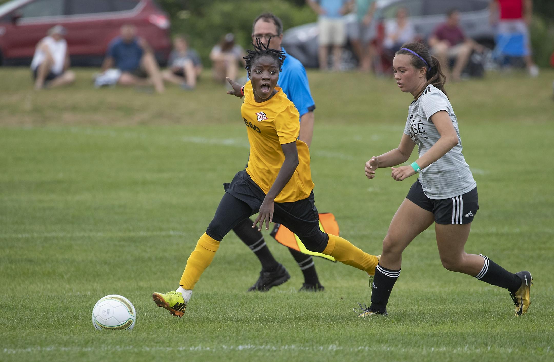 Monrovia Football Academy's Blessing Kieh controlled the ball down the field past an Eclipse Select MN Regional defender during the USA Cup tournament, Tuesday, July 16, 2019 at the National Sports Center in Blaine, MN. The youth soccer team from Liberia traveled to Minnesota for its first trip to the States, to play in the mega-tourney and were supported by the local Liberian community. Monrovia defeated Minnesota 9-1.