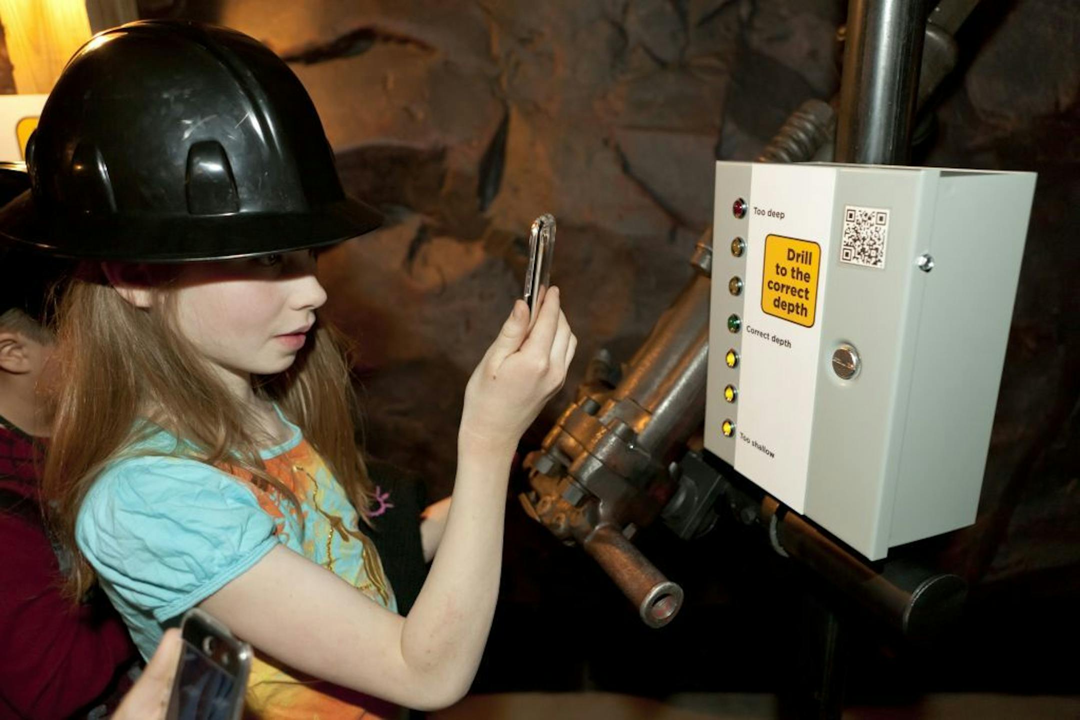 Katie Calger of Capitol Hill Magnet School in St. Paul uses a smart phone to "drill" in a mine exhibit at the Minnesota History Center earlier this year,