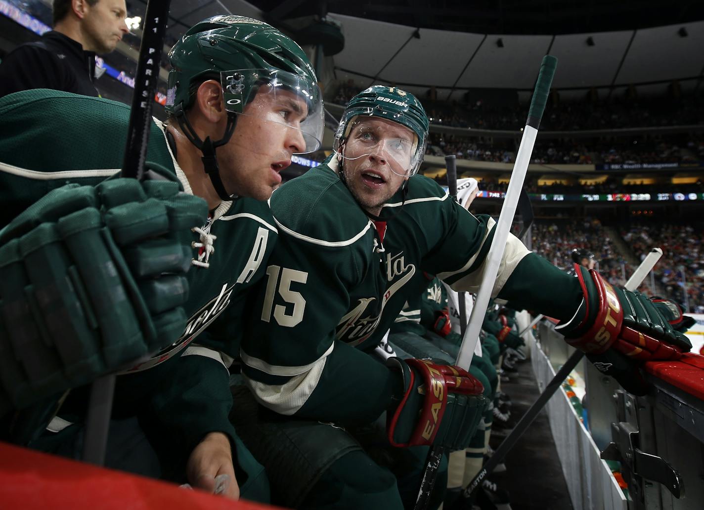 Zach Parise (11) and Dany Heatley (15) spoke on the bench in the first period. Minnesota beat Winnipeg by a final score of 2-1.