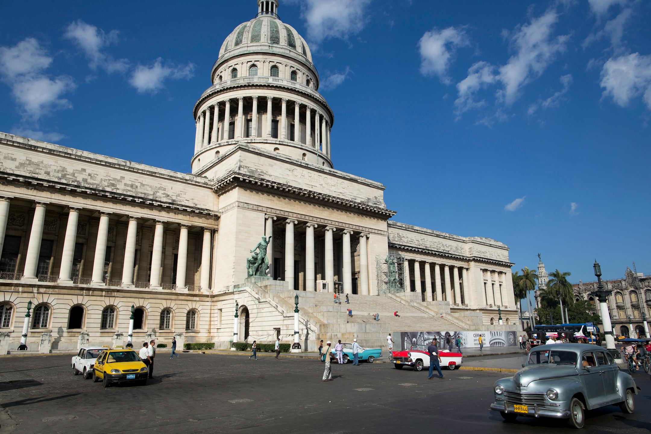 Road traffic is seen outside the national Capitol building in Havana, Cuba, on Thursday, Jan. 17, 2013. In a country where the average monthly salary is $19, according to Cuba's statistics agency, even buying an airplane ticket will be beyond the reach of most of the island's 11 million residents as President Raul Castro begins easing travel rules on the communist island. Photographer: Andrey Rudakov/Bloomberg