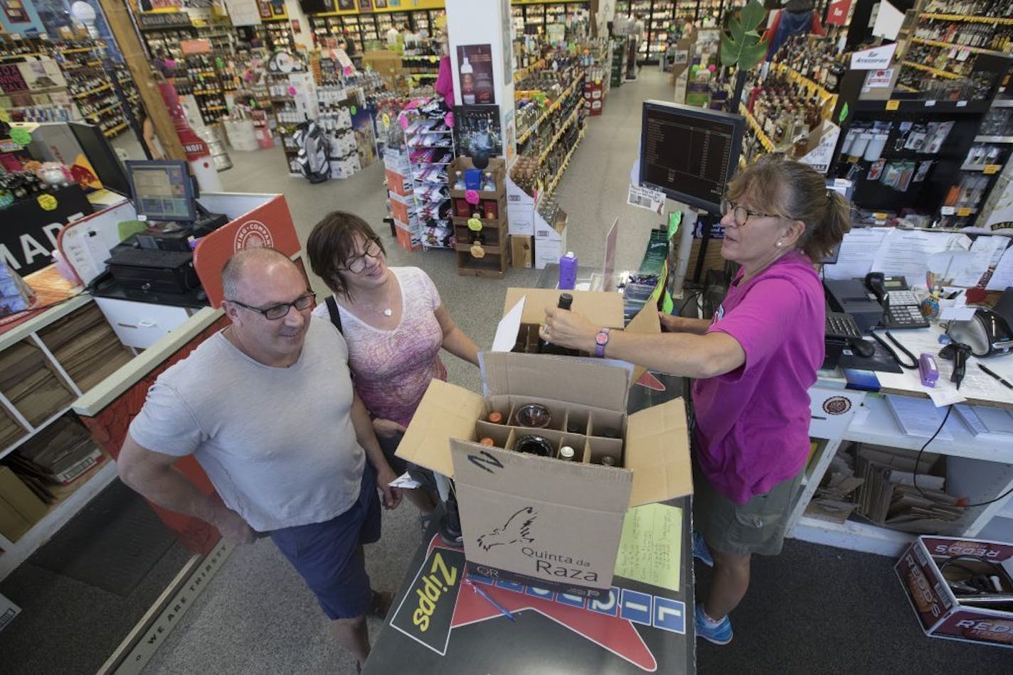 Jennifer Schoenzeit, co-owner of Zipps Liquor, checked out customers on Sunday.