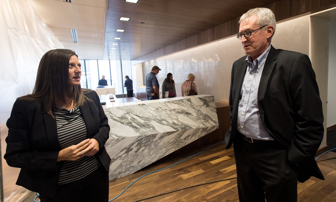 Dennis O'Malley, managing partner at Lindquist & Vennum LLP, and Chief Administrative Officer Dawn Costa talked during a tour of their firm's new offices Wednesday. ] (AARON LAVINSKY/STAR TRIBUNE) aaron.lavinsky@startribune.com Law firms are known for their sprawling and sometimes braggadocios offices complete with large private corner suites reserved for partners. With their industry under attack by virtual upstarts like LegalZoom, law firms are experimenting with reducing and repurposing offic