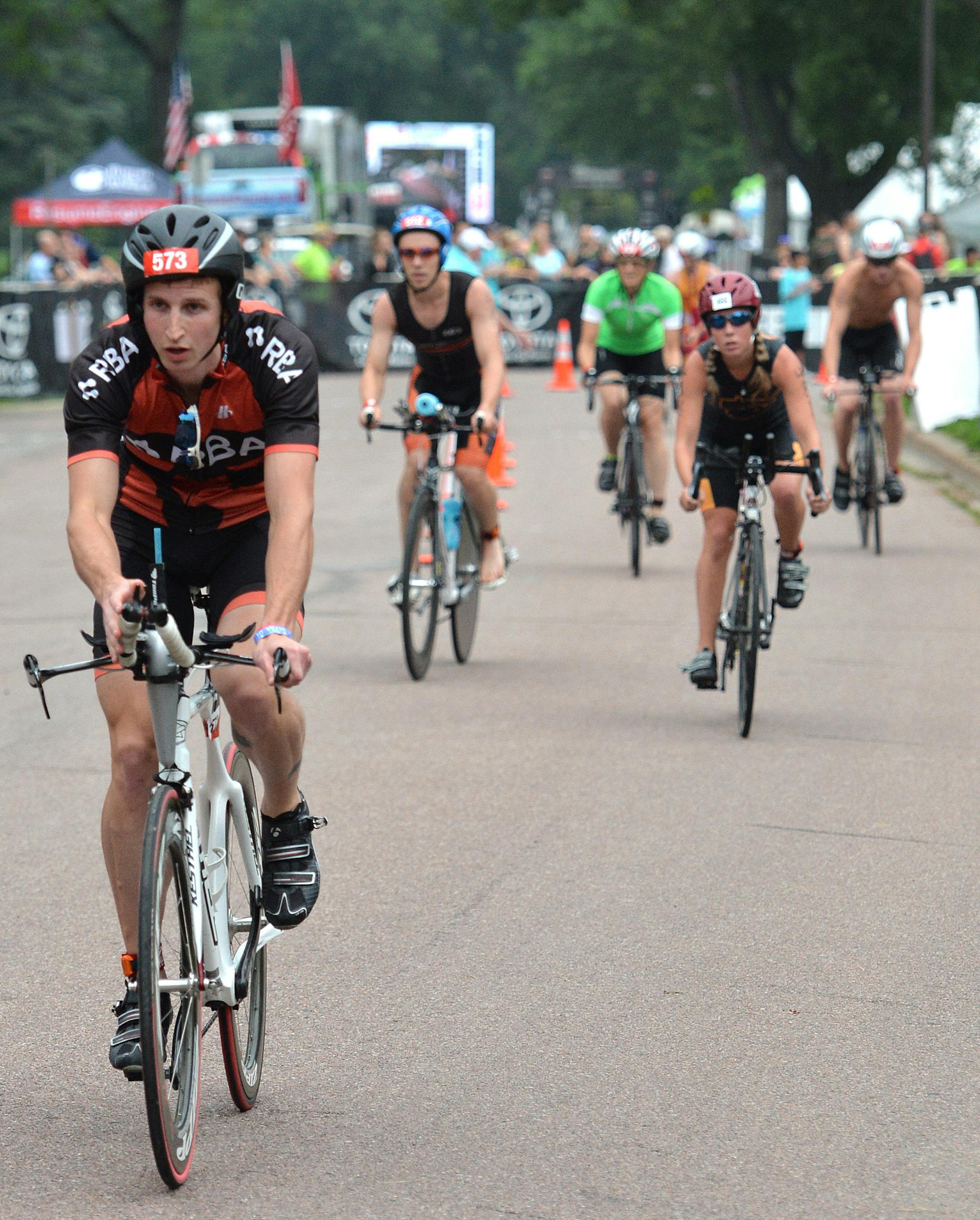 Triathletes gain speed at the start of the 16.79 mile bike ride of the 12th annual Life Time triathlon at Saturday morning at Lake Nokomis. ] (SPECIAL TO THE STAR TRIBUNE/BRE McGEE)