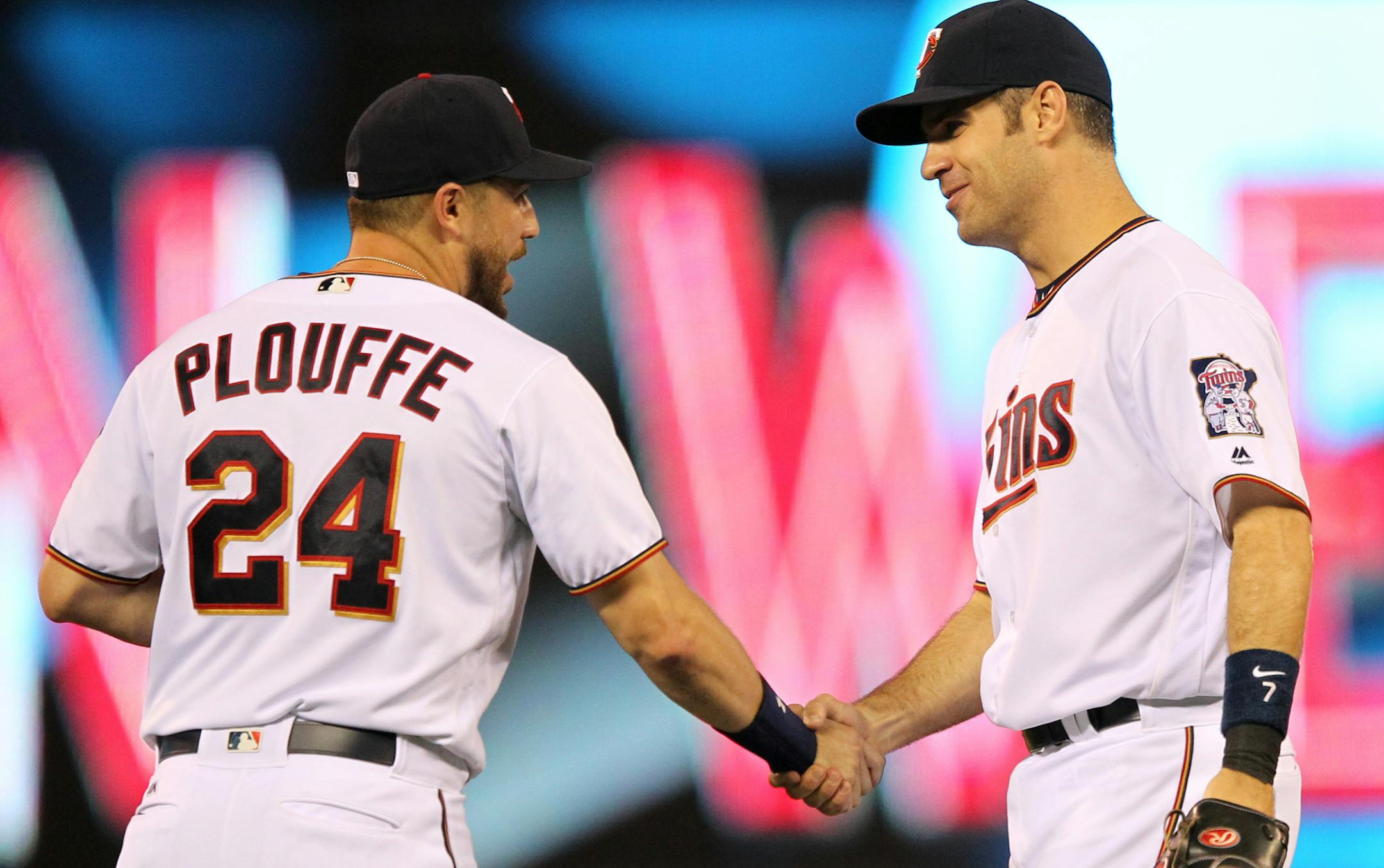 Minnesota Twins Trevor Plouffe shakes hands with Twins Joe Mauer after the Twins defeated the Houston Astros 3-1 during a baseball game on Monday, Aug., 8, 2016 in Minneapolis. (AP Photo/Andy Clayton-King) ORG XMIT: MNAK215