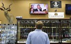 Brett Busbee, sales associate at Southeastern Armory, a gun store in Augusta, Ga., watches as President Obama speaks at the White House about his gun 