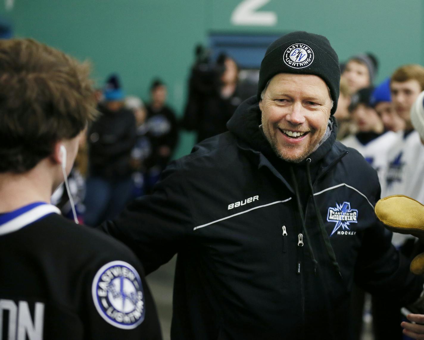 Mike Schoonover shook hands with Eastview hockey players as they welcome the team to the ice at Hayes Arena Sunday November 16, 2014 in Apple Valley. Mike's son Patrick died Friday after collapsing on the ice.