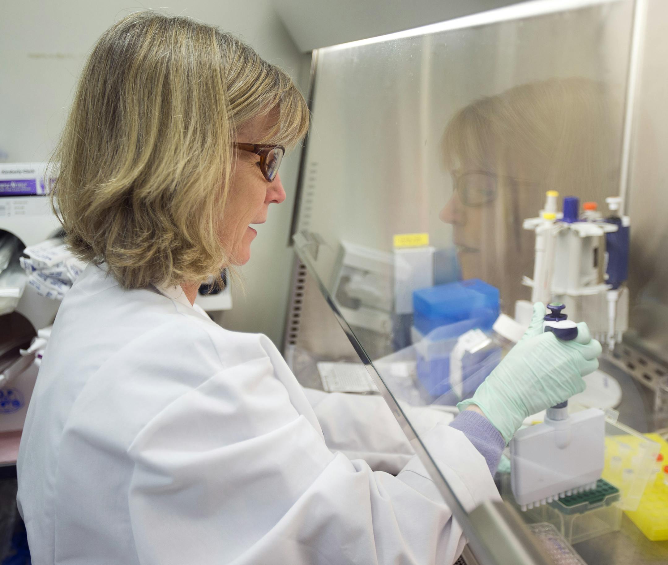 In this Thursday, Feb. 28, 2013 photo, Merck scientist Janet Lineberger conducts research to discover new HIV drugs in West Point, Pa. The health care industry has announced about $438 billion worth of mergers and acquisitions worldwide so far, about 14 percent of the $3.2 trillion total for all industries, according to data provider Dealogic. Merck & Co. agreed in June to pay nearly $4 billion for Idenix Pharmaceuticals Inc. to combine that company's hepatitis C medicines with its own. (AP Phot