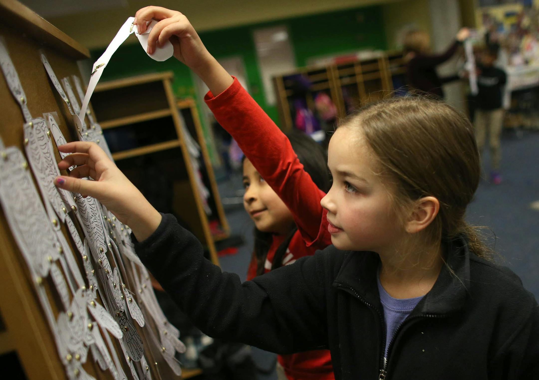 Samantha O'Brien, 8, and Carolina Sierra, 8, took a look at skeletons created by their fellow third graders during class ] (KYNDELL HARKNESS/STAR TRIBUNE) kyndell.harkness@startribune.com At FAIR School downtown in Minneapolis Min., Tuesday, January 20, 2015. With the West Metro Education Program on the verge of getting out of the school business, the future of two of the metro-area's integration districts seems questionable at best.