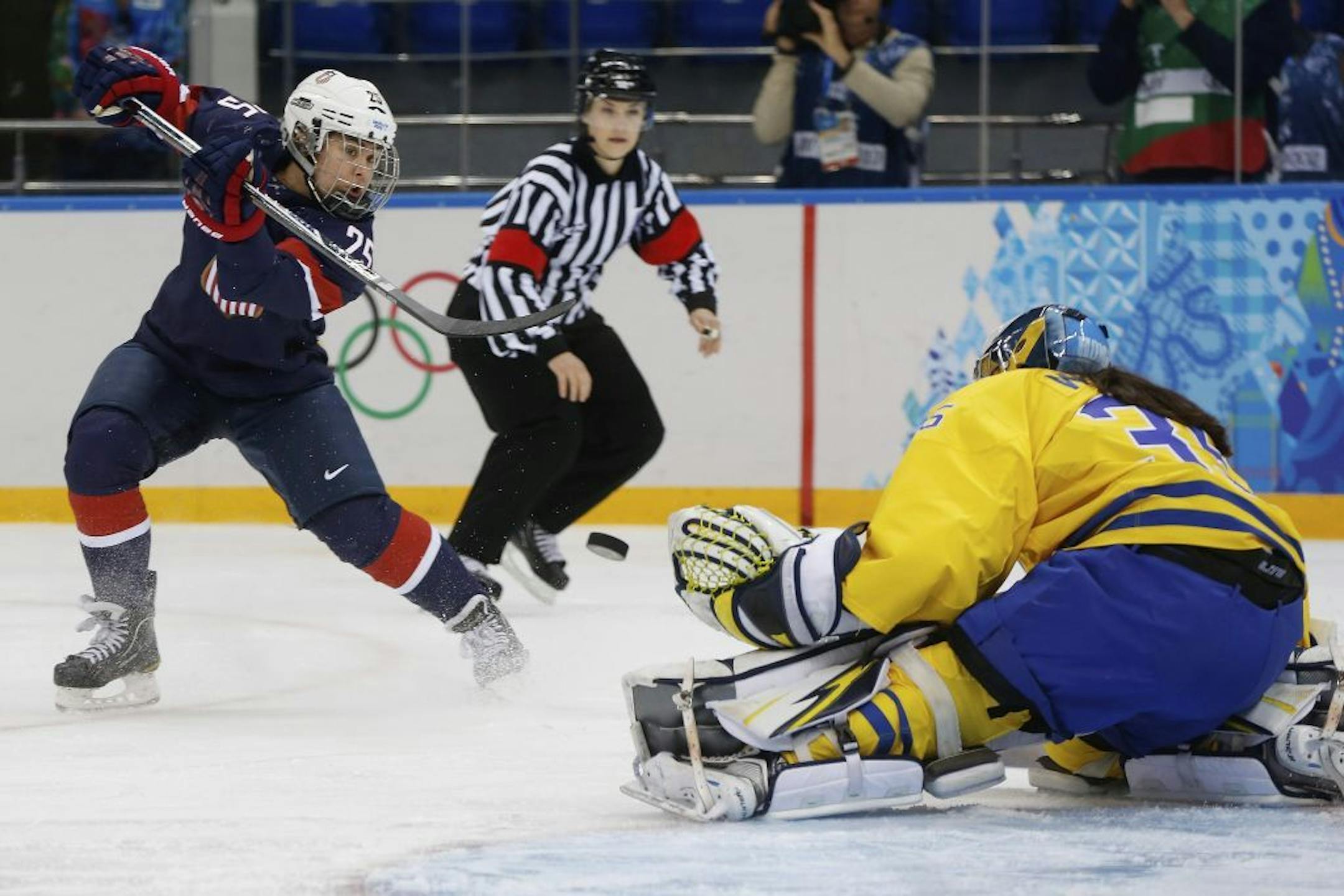 Alex Carpenter of the United States shoots on goalkeeper Valentina Wallner of Sweden during the first period of the 2014 Winter Olympics women's semifinal ice hockey game at Shayba Arena Monday, Feb. 17, 2014, in Sochi, Russia.