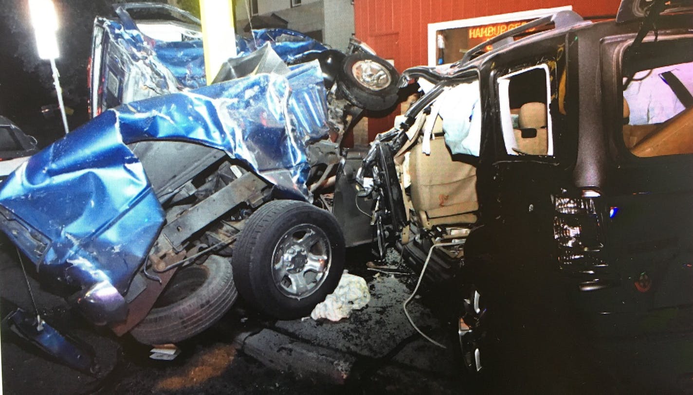 A view of the crash, with the victims' blue pickup truck wrapped around a pole outside of Matt's Bar.