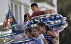 Refugee children have fun on a merry-go-round in Dortmund, Germany, Monday, Aug. 31, 2015. The children were invited by the city to a local fun fair. 