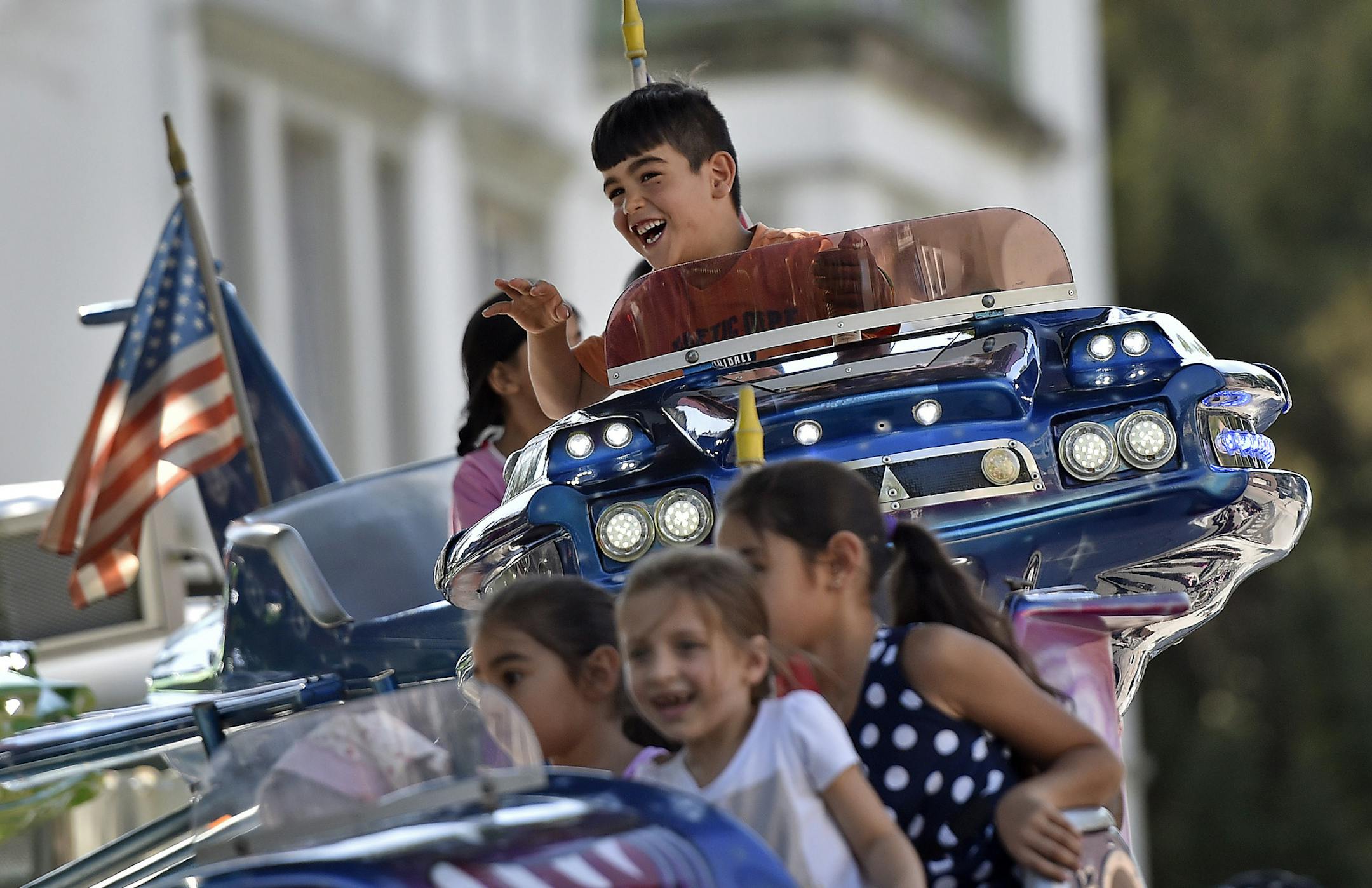 Refugee children have fun on a merry-go-round in Dortmund, Germany, Monday, Aug. 31, 2015. The children were invited by the city to a local fun fair. While Germany is preparing to accept at least 800,000 migrants this year, other European countries have not agreed to accept such large numbers of migrants. (AP Photo/Martin Meissner)