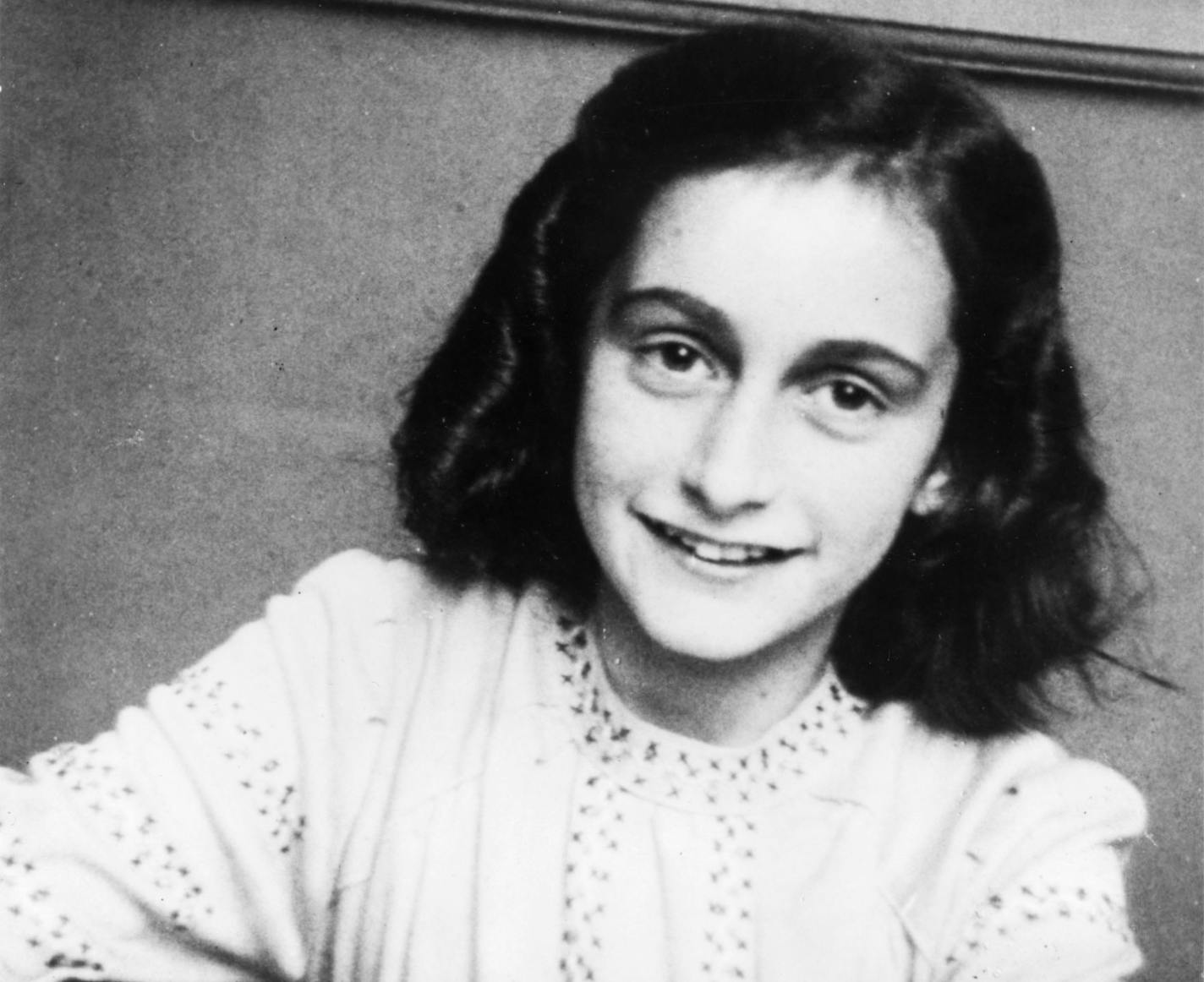 Anne Frank sitting in front of her schoolbook. She wrote the famous book THE DIARY OF ANNE FRANK during her years hidden in an attic during the Jewish holocaust by the Nazis during World War II. ORG XMIT: MIN2013061715481776