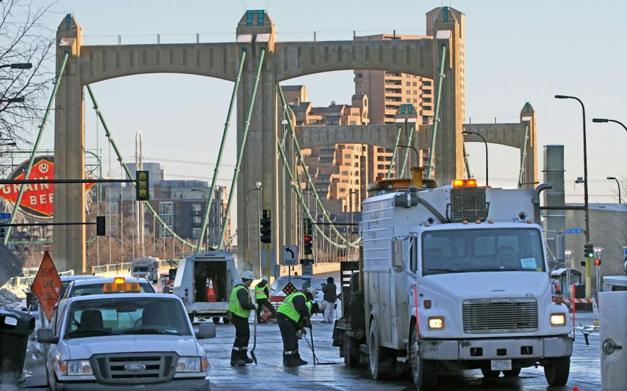 Utility workers opened sewer covers along Henneping Ave near the site of the water main break in downtown Minneapolis on 1/4/13.