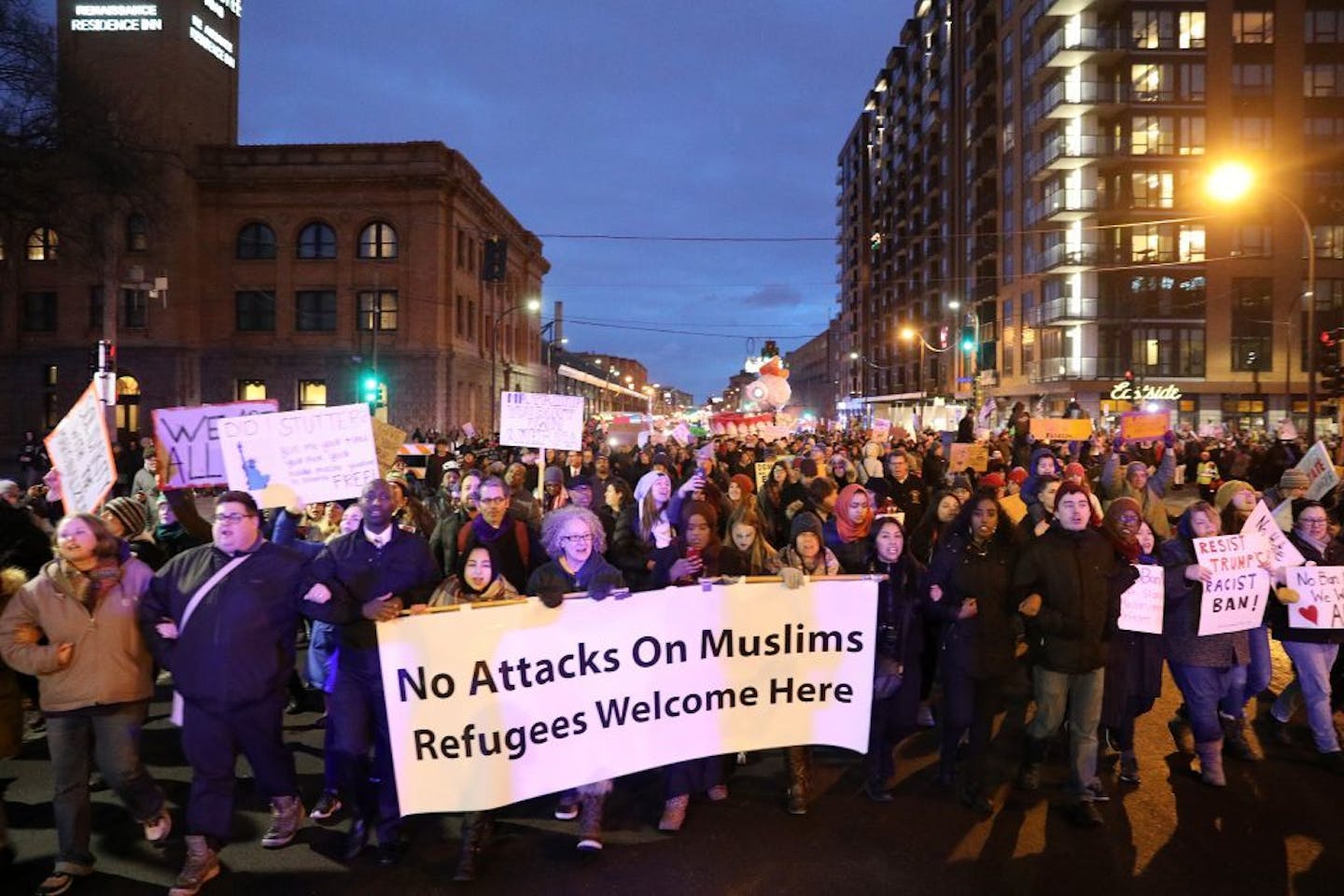 Protesters held signs and chanted as they marched against President Trump's temporary immigration ban on seven predominantly Muslim countries Tuesday.