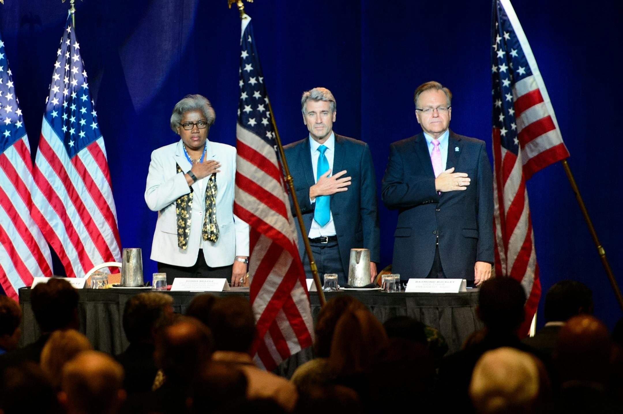 Donna Brazille, Former Minneapolis Mayor R.T. Rybak and Raymond Buckley placed hands over hearts as Members of the United States Secret Army Special Guerrilla Unit Vietnam War Lao/Hmong Veterans from St. Paul carried the colors at the start of the DNC meeting.