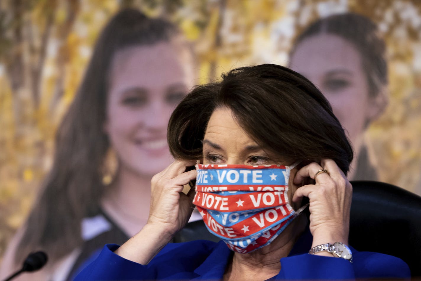 Sen. Amy Klobuchar, D-Minn., puts her face mask back on after speaking during a confirmation hearing for Supreme Court nominee Amy Coney Barrett before the Senate Judiciary Committee, Monday, Oct. 12, 2020, on Capitol Hill in Washington.