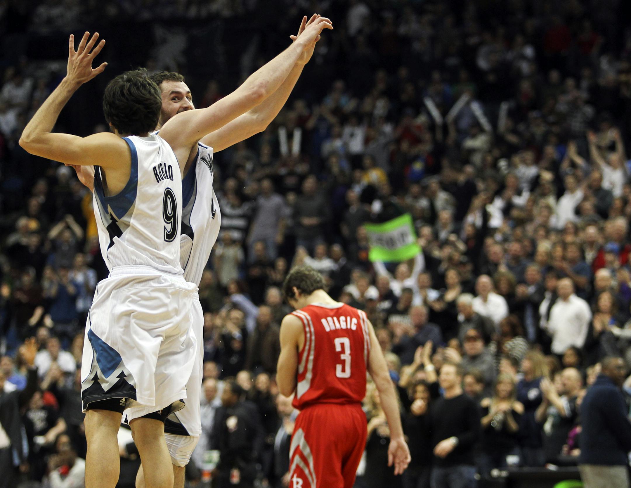 The Minnesota Timberwolves Ricky Rubio (9) and Kevin Love (42) celebrate at the end of their 100-91 win over the Houston Rockets Saturday, Feb. 4, 2012, at the Target Center