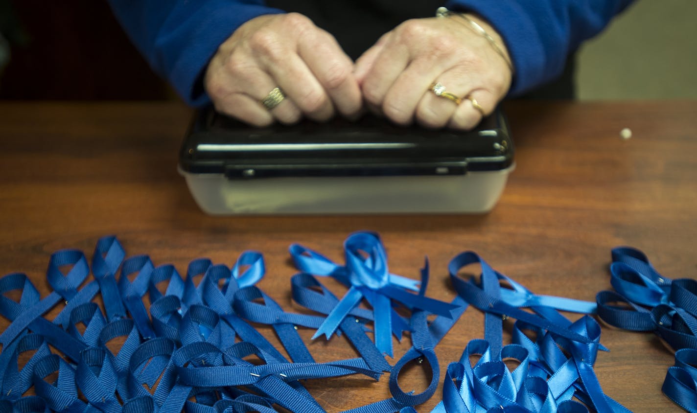 Julie Bayer took donations and handed out blue ribbons to attendees of Friday night's pro-police rally in Coon Rapids. ] (AARON LAVINSKY/STAR TRIBUNE) aaron.lavinsky@startribune.com A pro-police rally and concert in was held at the American Legion Post in Coon Rapids on Friday, Oct. 23, 2015.