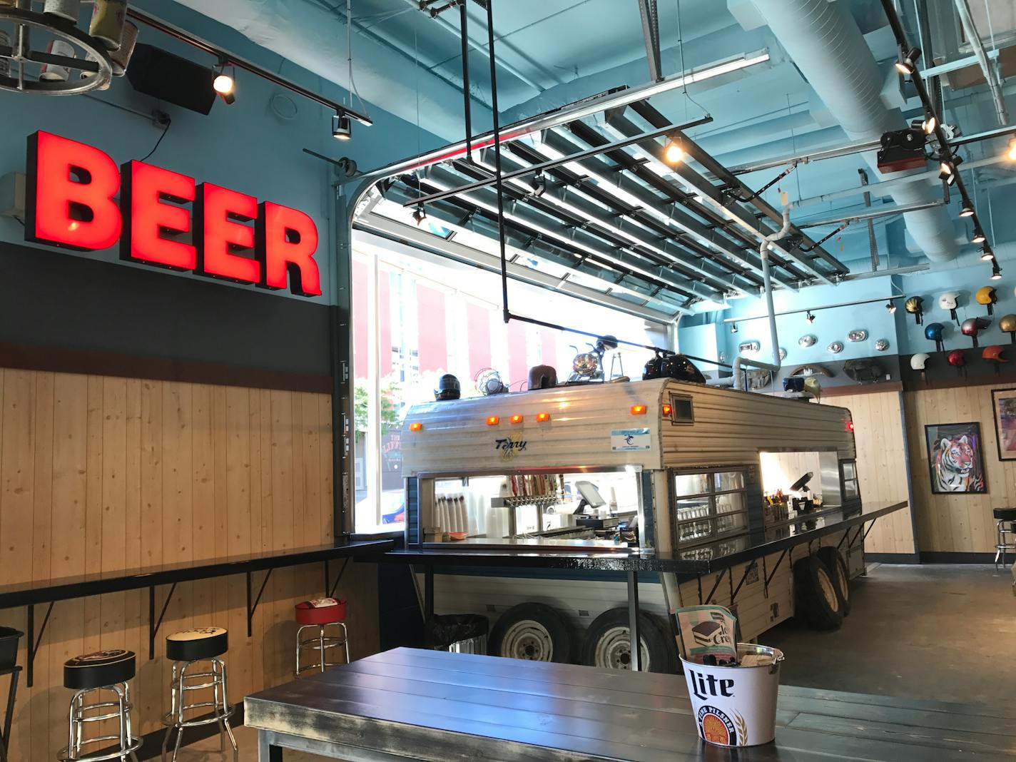 The interior of Truck Park is filled with stationary food trucks serving different menus.