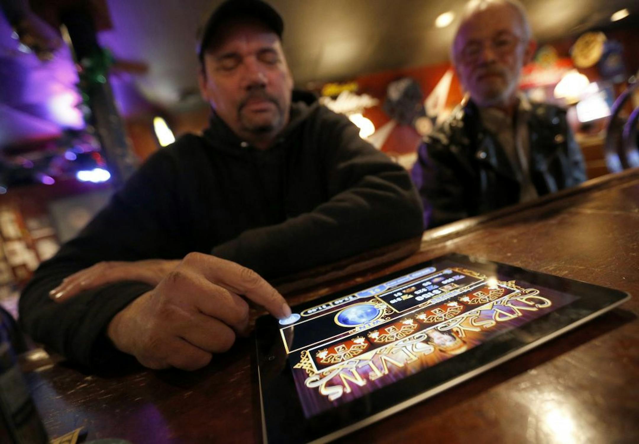 Dave Stokes of St. Paul played an electronic pulltab game at Skinner's Pub on Wednesday afternoon.